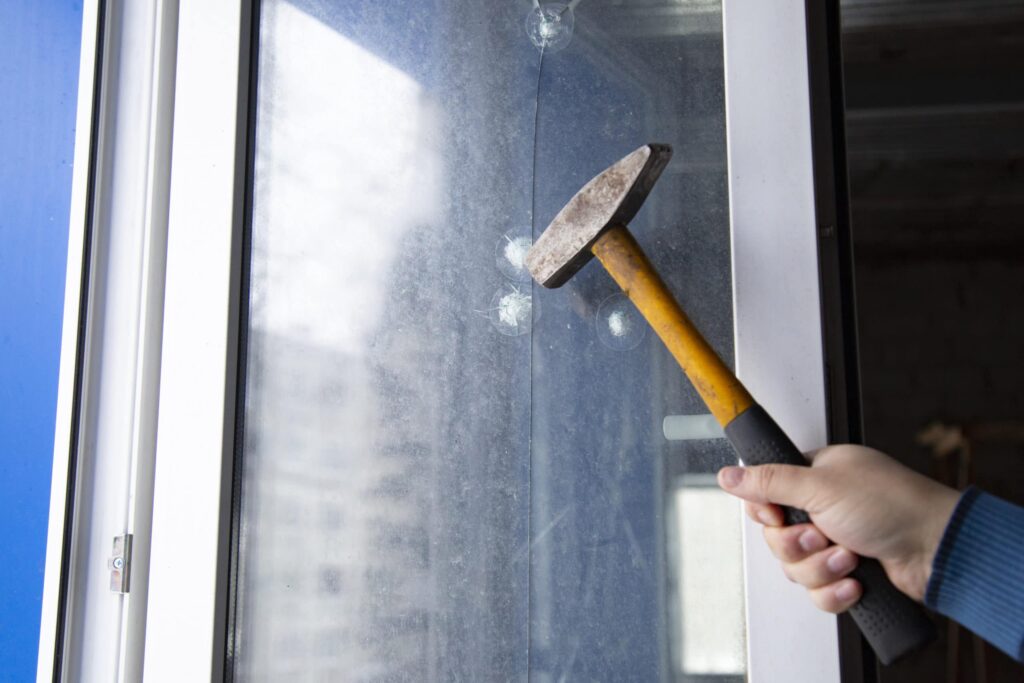 Hammer Trying to Smash Security Window Film