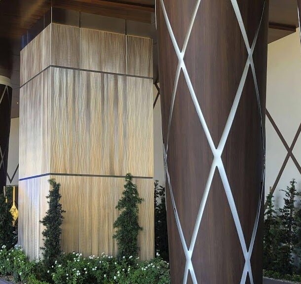 Modern woodgrain column wrap by Engineered Group in corporate office lobby.